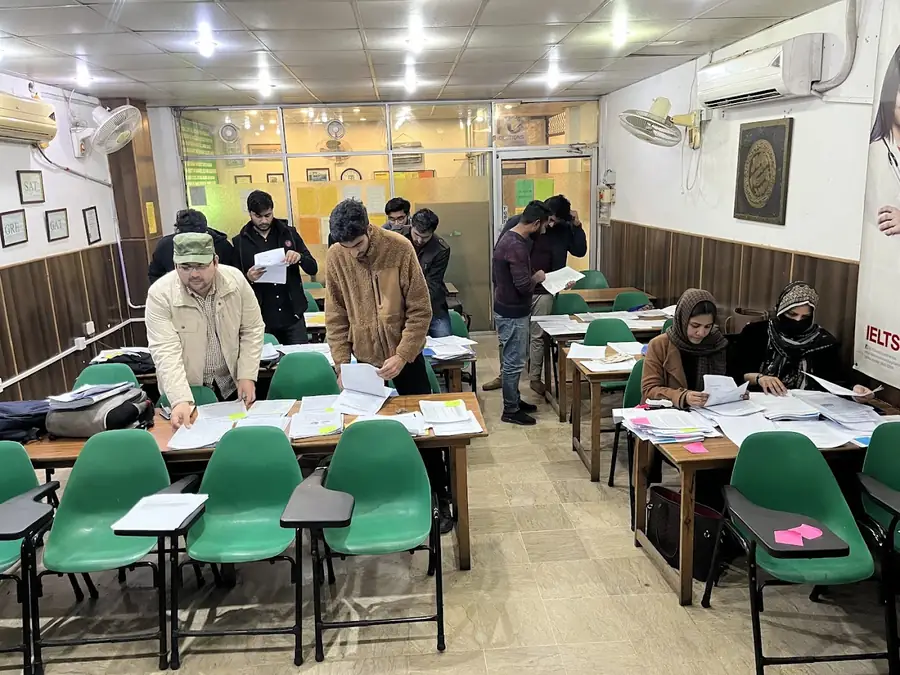 Pacans students writing a paper in class